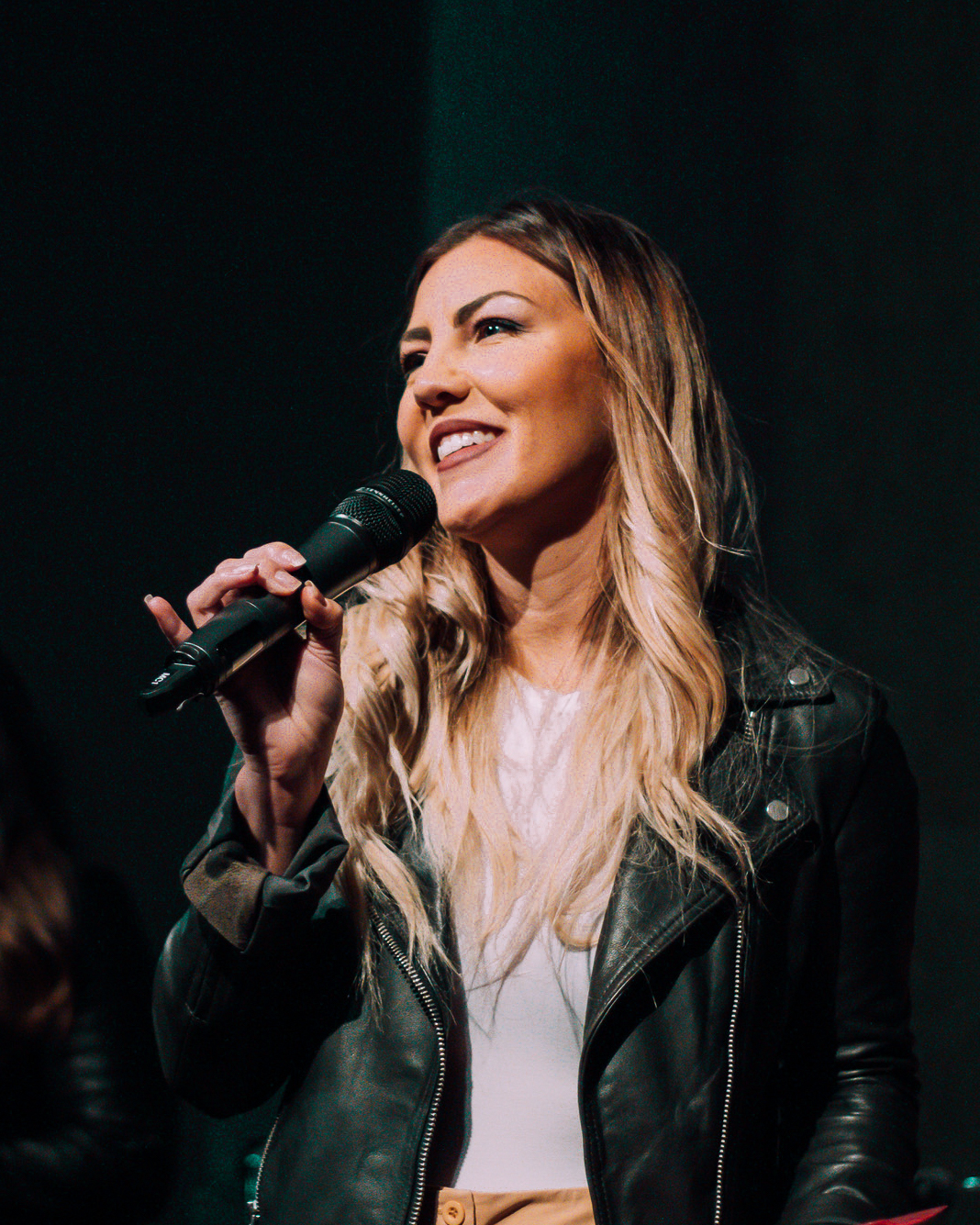 Dr. Julia Garcia speaking with microphone